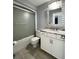 Bathroom featuring a shower-tub combination with glass doors and vanity with drawers at 7360 Ulmerton Rd # 16A, Largo, FL 33771