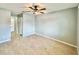 Spacious bedroom with tile flooring, ceiling fan, and neutral-colored walls at 7360 Ulmerton Rd # 16A, Largo, FL 33771