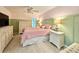 Stylish pink bedroom with wood trim, ceiling fan, and matching dressers at 7360 Ulmerton Rd # 16A, Largo, FL 33771