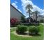 Community entrance sign framed by beautiful landscape in RoseTree Village at 7360 Ulmerton Rd # 16A, Largo, FL 33771
