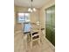 Inviting dining area with a wood table, white chairs and a unique cabinet for extra storage at 7360 Ulmerton Rd # 16A, Largo, FL 33771