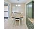 Bright dining area features a wood table, white chairs and cabinet, and natural light from the window at 7360 Ulmerton Rd # 16A, Largo, FL 33771