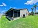 Exterior features screened in patio, lawn, and air conditioning unit at 7360 Ulmerton Rd # 16A, Largo, FL 33771