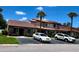 Exterior view of the townhome with well-maintained landscaping and assigned parking spaces at 7360 Ulmerton Rd # 16A, Largo, FL 33771