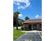Charming villa entrance with front parking and lovely, tropical landscaping at 7360 Ulmerton Rd # 16A, Largo, FL 33771
