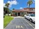 Charming townhome exterior with lush landscaping and parking in front at 7360 Ulmerton Rd # 16A, Largo, FL 33771