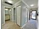 Hallway featuring a tile rug, linen closet, and bathroom at 7360 Ulmerton Rd # 16A, Largo, FL 33771