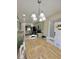 Kitchen dining area with stylish light fixture, green cabinets, and stainless steel appliances at 7360 Ulmerton Rd # 16A, Largo, FL 33771