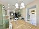 Kitchen dining area with stylish light fixture, green cabinets, and stainless steel appliances at 7360 Ulmerton Rd # 16A, Largo, FL 33771