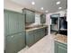 Stylish kitchen features painted cabinets, granite counters and stainless-steel appliances at 7360 Ulmerton Rd # 16A, Largo, FL 33771