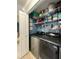 Modern laundry room with side-by-side washer and dryer, and shelving at 7360 Ulmerton Rd # 16A, Largo, FL 33771