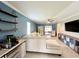 Open-concept living room with a large sectional and access to a screened in porch at 7360 Ulmerton Rd # 16A, Largo, FL 33771