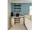 Coffee bar with sliding barn doors, granite counter top, and floating shelving in the living room at 7360 Ulmerton Rd # 16A, Largo, FL 33771