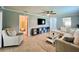 Comfortable living room with a ceiling fan, a TV, and a sofa with a coffee table at 7360 Ulmerton Rd # 16A, Largo, FL 33771