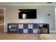 Living room showcasing entertainment center with blue storage baskets and television at 7360 Ulmerton Rd # 16A, Largo, FL 33771