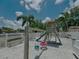 Community playground features a swing set and a slide, perfect for children to enjoy in a safe environment at 7360 Ulmerton Rd # 16A, Largo, FL 33771