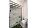 Full bathroom with white tiled shower and sliding glass door at 7360 Ulmerton Rd # 16A, Largo, FL 33771