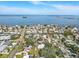 Panoramic aerial view of waterfront homes with canal access to bay, beautiful neighborhood, and picturesque water views at 75 New Jersey Dr, Dunedin, FL 34698