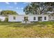 Spacious backyard offers a patio area, lush green grass, and a well-maintained exterior, perfect for outdoor living at 75 New Jersey Dr, Dunedin, FL 34698