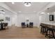 Spacious basement features modern finishes, including a bar area and accent wall at 75 New Jersey Dr, Dunedin, FL 34698