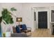 Basement seating area with blue accent pillows and a view of a black painted door at 75 New Jersey Dr, Dunedin, FL 34698