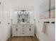 Bathroom with double sink vanity, framed mirror, and modern fixtures at 75 New Jersey Dr, Dunedin, FL 34698