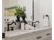 Bathroom countertop with double sinks, modern fixtures, and marble countertop at 75 New Jersey Dr, Dunedin, FL 34698
