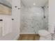 Bathroom shower with black fixtures and modern marble tile at 75 New Jersey Dr, Dunedin, FL 34698