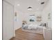 Well-lit bedroom featuring white walls, a stylish bed with storage, and modern decor exudes comfort at 75 New Jersey Dr, Dunedin, FL 34698