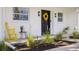 Inviting front porch featuring a stylish wreath, modern lighting, and tasteful decor, exuding curb appeal at 75 New Jersey Dr, Dunedin, FL 34698