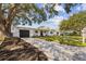 Charming single-story home boasts a well-maintained lawn, a welcoming front entrance, and an attached garage at 75 New Jersey Dr, Dunedin, FL 34698