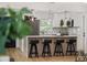 Stylish kitchen with modern appliances, white cabinets, an island with seating, and hardwood floors throughout at 75 New Jersey Dr, Dunedin, FL 34698
