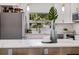 Bright kitchen with white cabinets, stainless steel appliances, and a view of the backyard at 75 New Jersey Dr, Dunedin, FL 34698