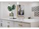 Elegant kitchen with white cabinetry, gold hardware, quartz countertops, and stylish decorative accents at 75 New Jersey Dr, Dunedin, FL 34698
