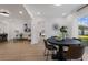 Open-concept living room and dining room with wood floors and backyard views at 75 New Jersey Dr, Dunedin, FL 34698