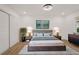 Main bedroom featuring a large bed, sliding closet door, wood-look flooring, and recessed lighting at 75 New Jersey Dr, Dunedin, FL 34698