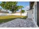 Spacious back yard with a private patio area and mature trees, perfect for relaxation and outdoor activities at 8418 Westridge Dr, Tampa, FL 33615