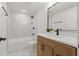 Well-lit bathroom featuring an undermount sink, marble shower, and a modern vanity at 8418 Westridge Dr, Tampa, FL 33615