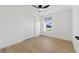 Bright bedroom features a closet and a window providing natural light, complemented by sleek, modern flooring at 8418 Westridge Dr, Tampa, FL 33615