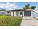 Lovely single-story home featuring a well-kept lawn, a welcoming front porch, and a one car garage at 8418 Westridge Dr, Tampa, FL 33615