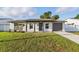 Single-story home boasting a well-kept lawn, front porch, and attached one car garage at 8418 Westridge Dr, Tampa, FL 33615