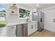 Bright, updated kitchen featuring white cabinetry, stainless steel appliances, and modern fixtures at 8418 Westridge Dr, Tampa, FL 33615