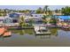 Waterfront backyard with boat dock, screened-in pool, and tropical landscaping, perfect for relaxation at 8711 Thornwood Ln, Tampa, FL 33615