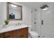 Bathroom featuring vanity and walk-in shower with a glass door and modern tile at 8711 Thornwood Ln, Tampa, FL 33615
