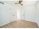 Bedroom featuring hardwood flooring, white walls and trim, and two closets at 8711 Thornwood Ln, Tampa, FL 33615