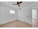 Bedroom featuring hardwood flooring, white walls and trim, and window with mini blinds at 8711 Thornwood Ln, Tampa, FL 33615