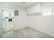 Bonus room with tile floors, storage cabinets and an open view into the kitchen at 8711 Thornwood Ln, Tampa, FL 33615