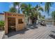 Backyard deck featuring a custom-built playhouse overlooking the canal at 8711 Thornwood Ln, Tampa, FL 33615