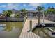 Private dock overlooking tranquil water with great views of the screened-in pool area at 8711 Thornwood Ln, Tampa, FL 33615