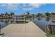 Picture of a wooden dock with a boat lift overlooking the waterway and the neighboring homes at 8711 Thornwood Ln, Tampa, FL 33615